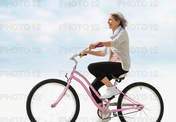 Senior woman riding bicycle.