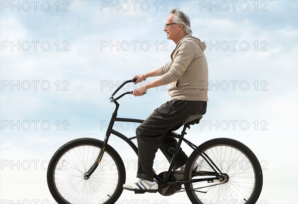 Senior man riding bicycle.