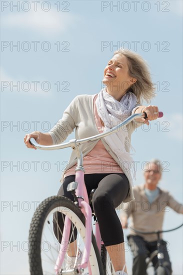 Senior couple riding bicycle.