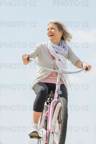 Senior woman riding bicycle.