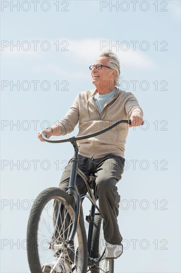 Senior man riding bicycle.