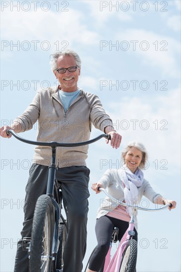 Senior couple riding bicycle.