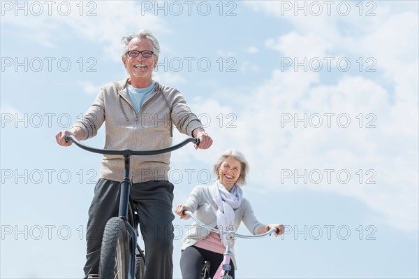 Senior couple riding bicycle.