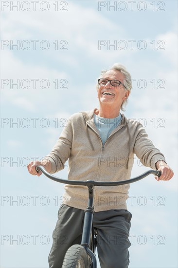 Senior man riding bicycle.