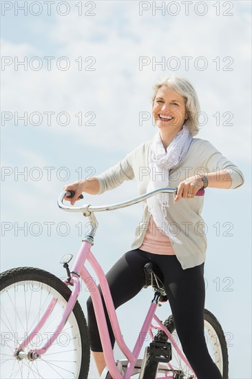 Senior woman riding bicycle.