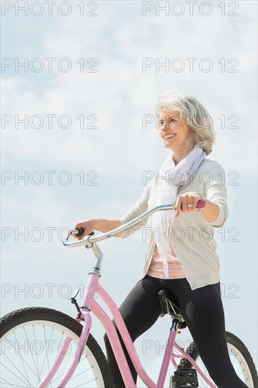 Senior woman riding bicycle.