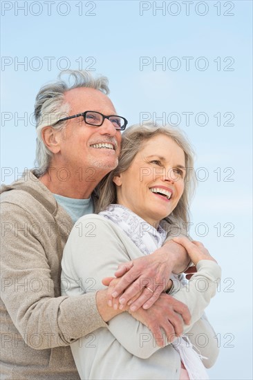 Senior couple embracing outdoors.