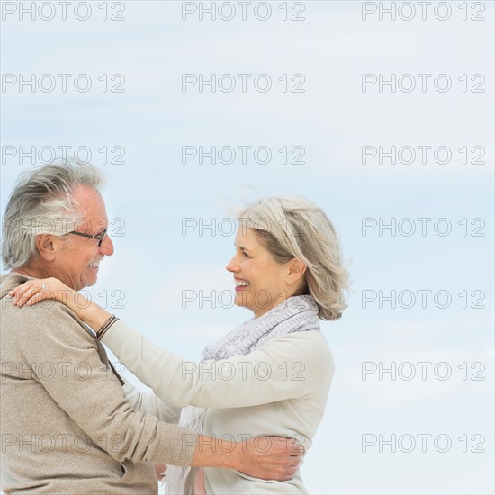 Senior couple embracing outdoors.