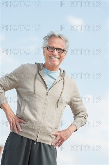 Portrait of senior man standing outdoors.