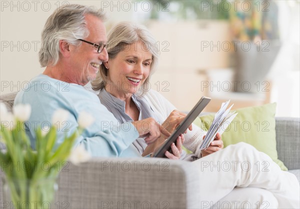 Senior couple paying bills via internet.