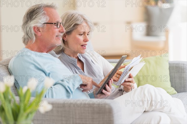 Senior couple paying bills via internet.