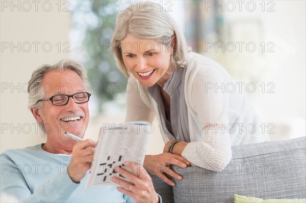 Senior couple doing crossword.