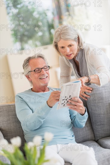 Senior couple doing crossword.