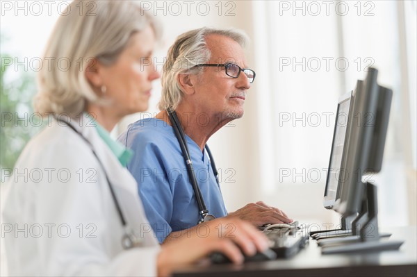 Female and male doctors working at computers.