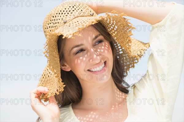 Portrait of beautiful young woman in sun hut.