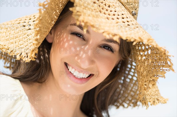 Portrait of beautiful young woman in sun hut.