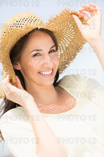 Portrait of beautiful young woman in sun hut.