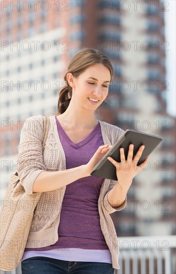 Young female using digital tablet.