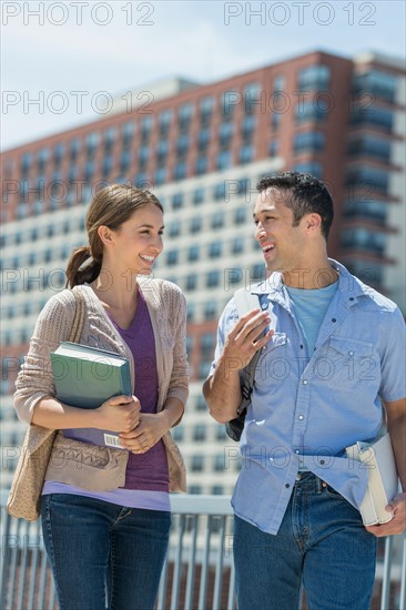 Male and female students walking in campus.