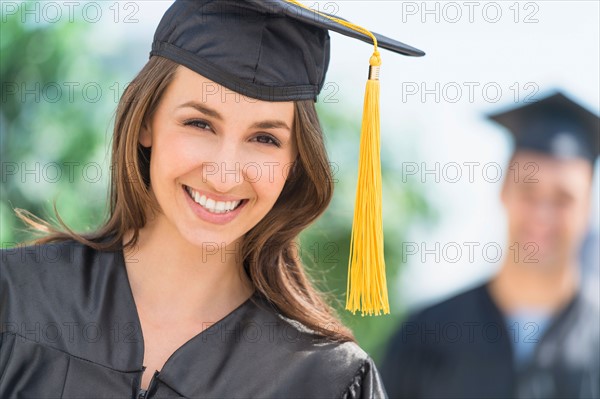 Female and male student on graduation ceremony.