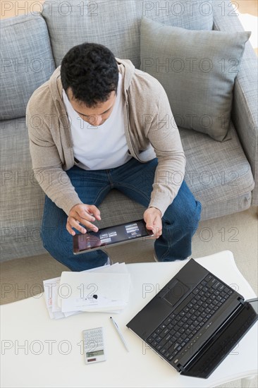 Young man doing home finances.