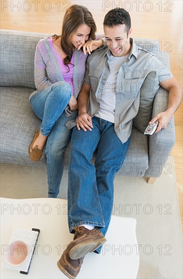 Young couple relaxing on sofa.