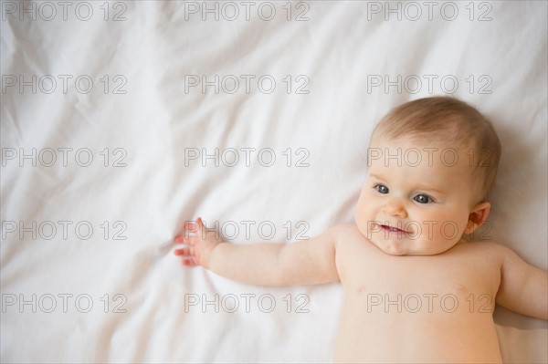 Portrait of baby girl (6-11 months) lying down