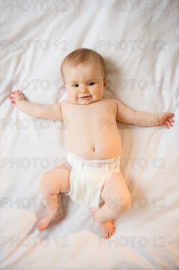 Portrait of baby girl (6-11 months) lying down