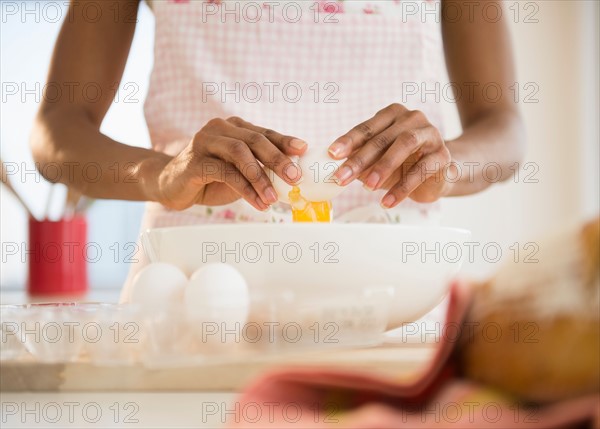 Mid section of woman separating eggs