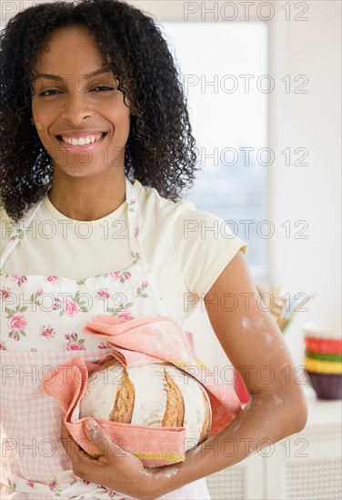 Portrait of woman holding bread