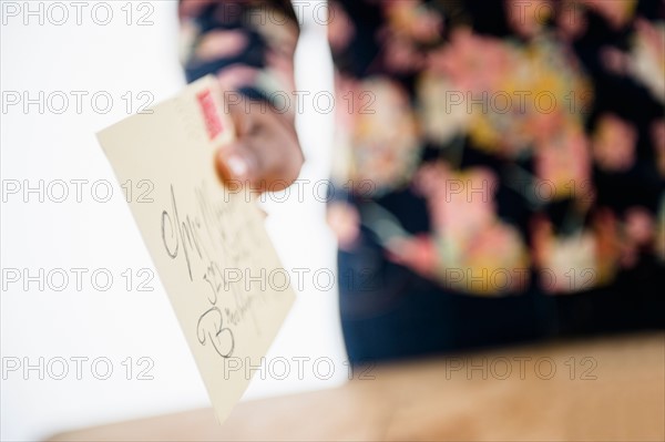 Close up of woman's hand holding letter