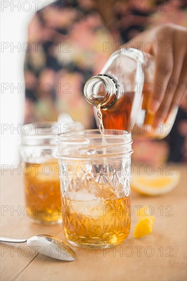 Close up of woman hand pouring whiskey