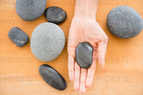 Close up of woman's hand holding pebble