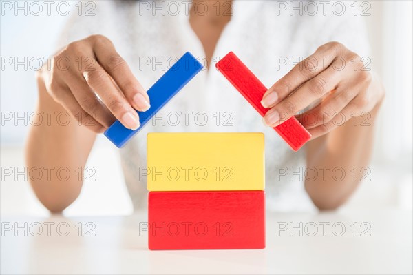 Close up of woman's hands holding blocks