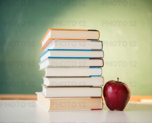 Studio Shot of books stacked and apple next to it