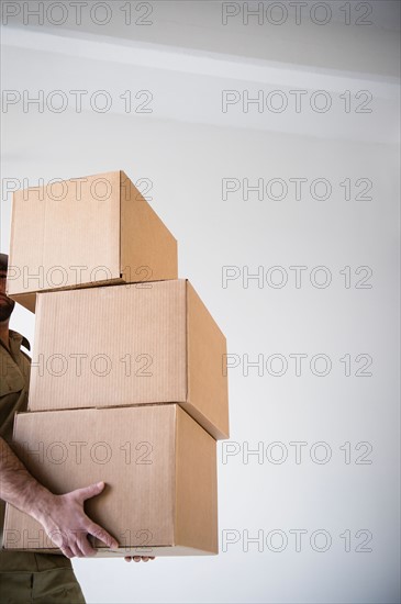 Man carrying stack of boxes