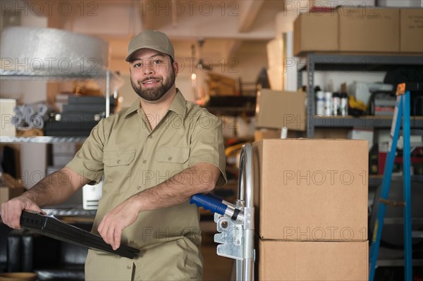 Portrait of delivery man in warehouse