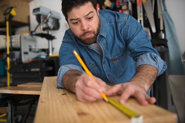 Portrait of man doing marks on wooden board