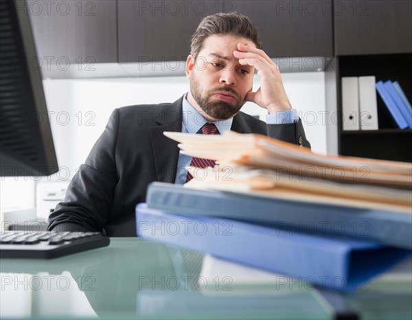 Portrait of tired businessman sitting in office