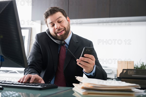 Portrait of busy man in office