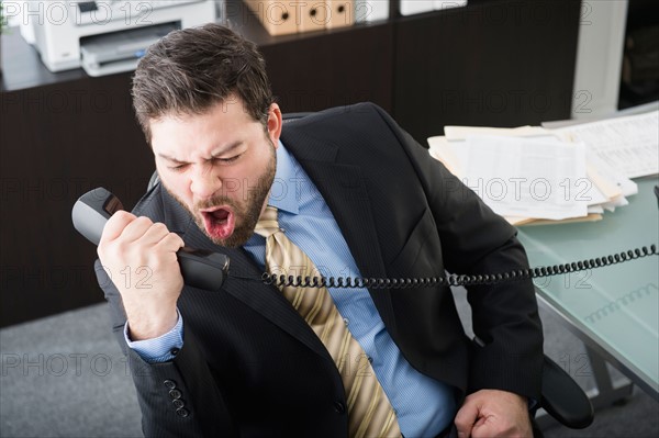 Portrait of man shouting on phone