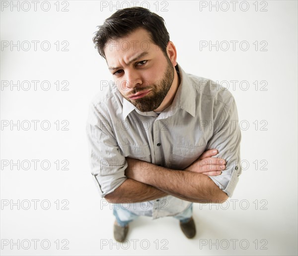 Elevated view of irritated man, arms crossed