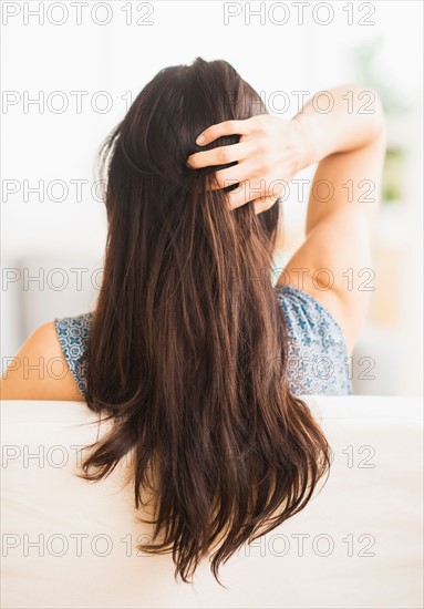 Rear view of woman with hand in her hair