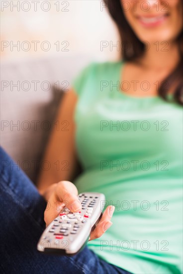 Close up of woman's hand holding remote control