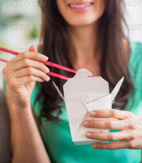 Portrait of woman eating take out food