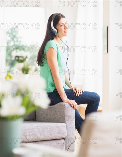 Portrait of woman listening to music on headphones