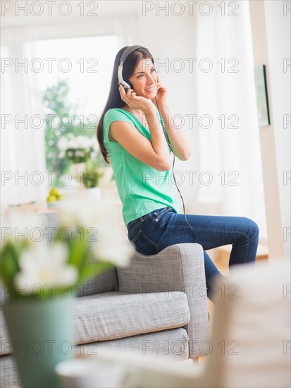 Portrait of woman listening to music on headphones