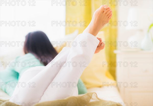 Woman lying down on bed