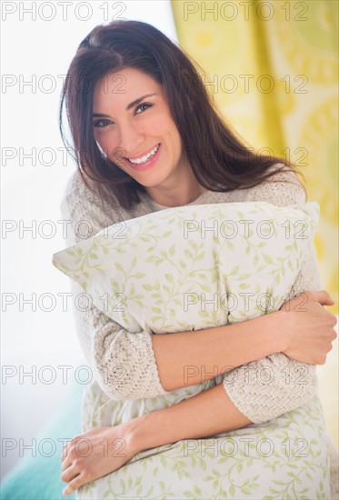 Portrait of woman holding pillow, Looking at camera