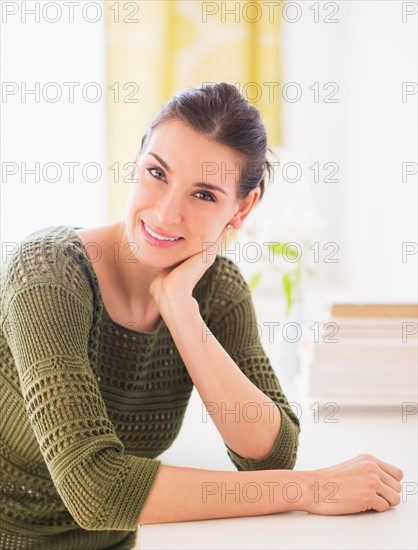 Portrait of happy woman sitting at table